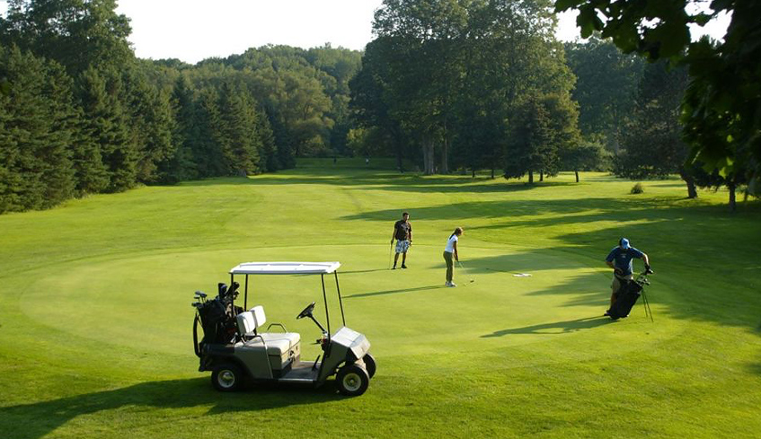 3 golfers playing a round of golf at East Park Golf Gardens locate din London, Ontario