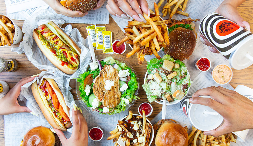 A table top view of various meals from South St. Burger and drinks
