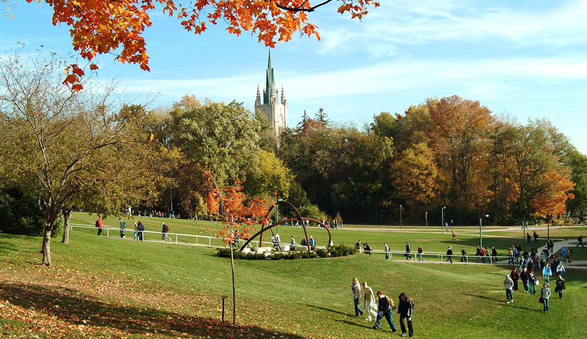 Students walking on Western University's campus grounds on a sunny Fall day in London, Ontario, Canada