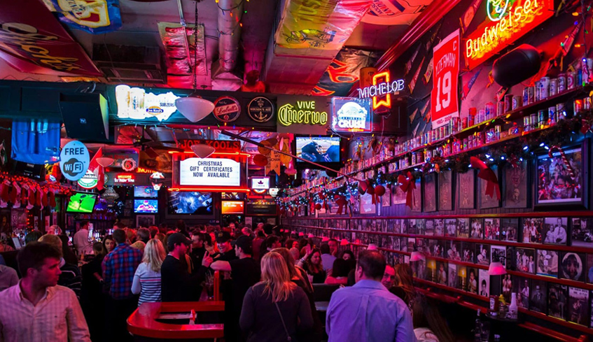 Large groups of people talking and mingling inside Joe Kool's main room located in London, Ontario